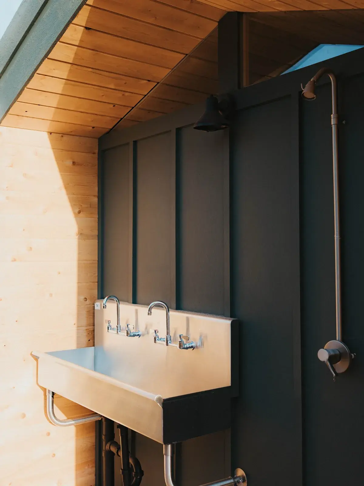 Trough sink with faucets in a Pine bathhouse