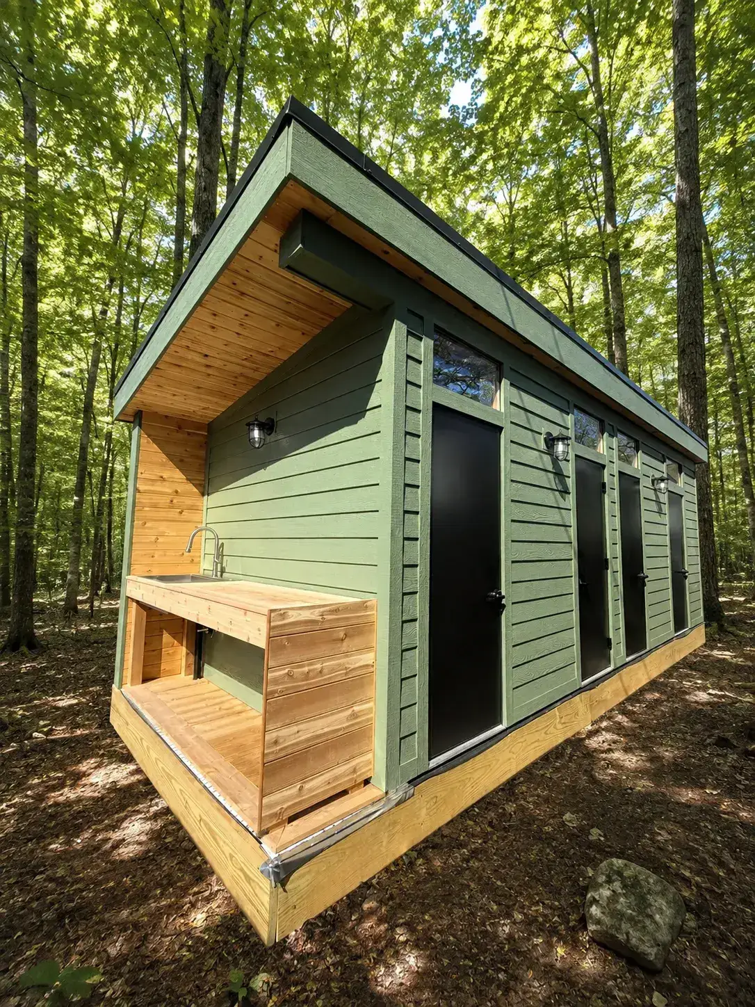 Green Pine mobile bathhouse with a cedar wash counter set in the forest