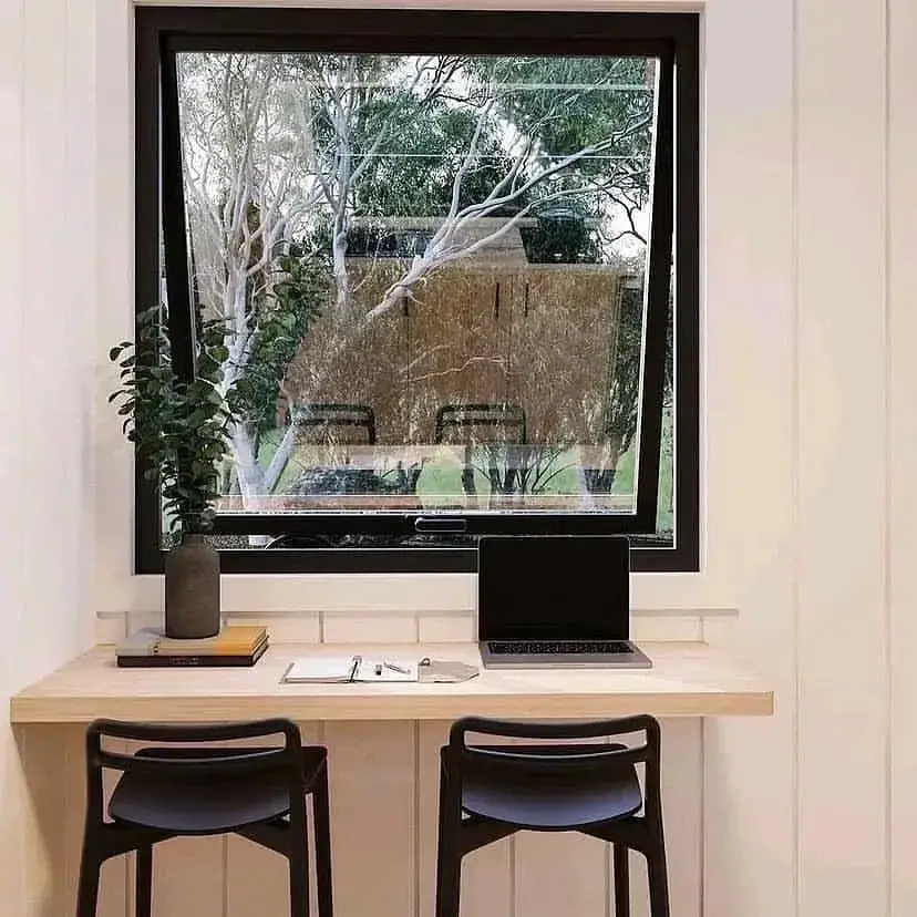 Cabin interior with a window desk looking out on the property
