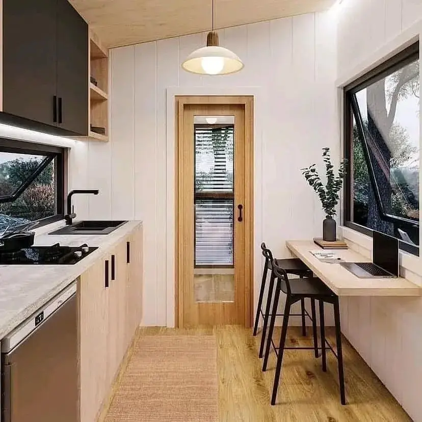 Cabin galley kitchen with a desk and storage within reach